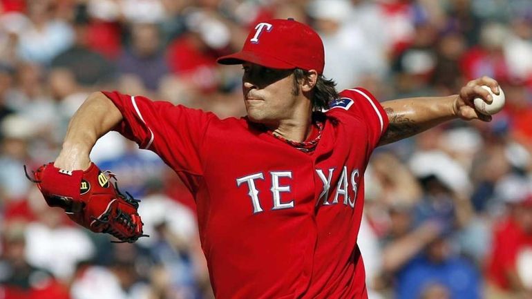 Texas Rangers starting pitcher C.J. Wilson (36) delivers during the...