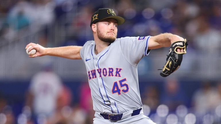 Christian Scott #45 of the Mets pitches against the Miami Marlins...