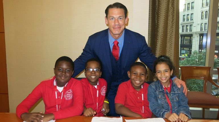 John Cena with Kidsday reporters, from left, Kader Kane, Quilla Banks,...