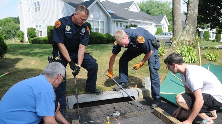 Suffolk County police emergency service officers work on rescuing a...