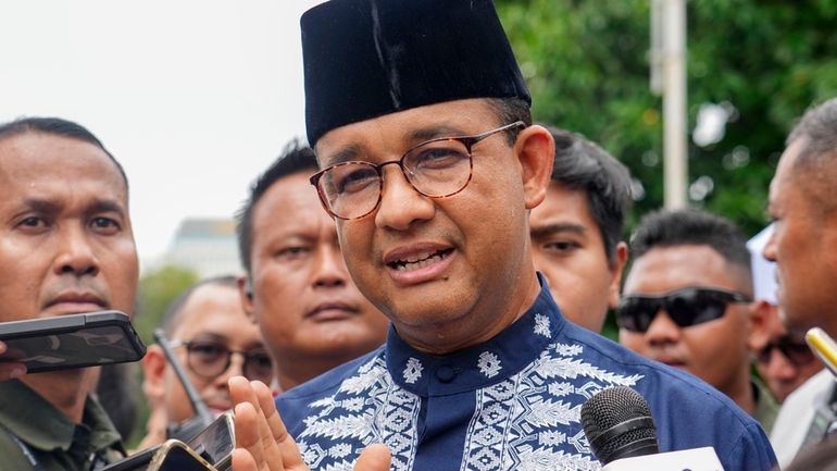 Presidential candidate Anies Baswedan talks to media after Friday prayer...