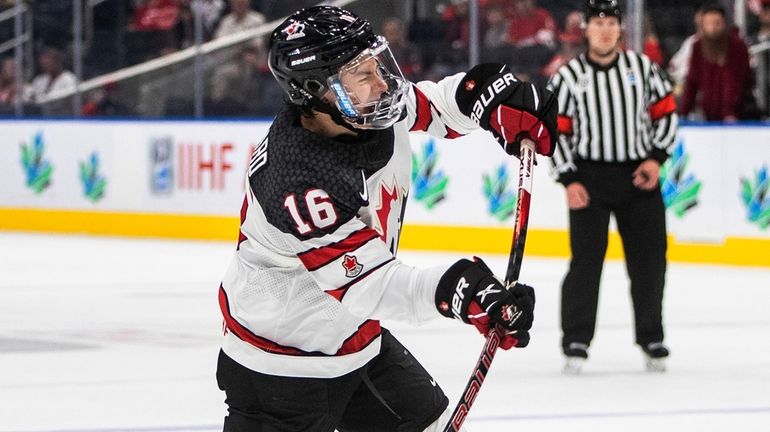 Canada's Connor Bedard (16) shoots against Latvia during the second...