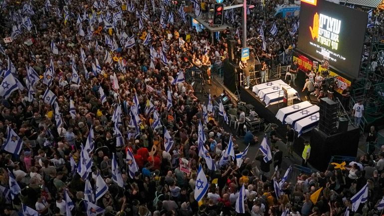 People take part in a protest calling for a deal...