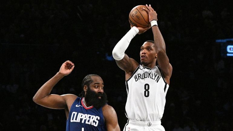 Nets guard Lonnie Walker IV shoots to score a three-point...