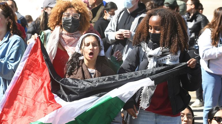 Several hundred students and pro-Palestinian supporters rally at the intersection...