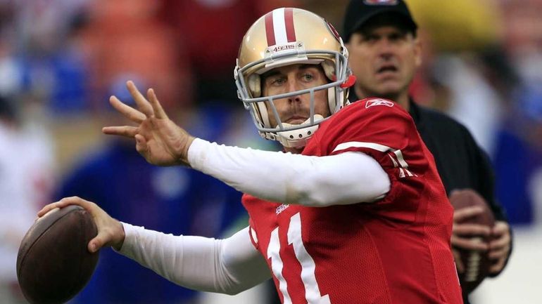 San Francisco 49ers head coach Jim Harbaugh watches as quarterback...