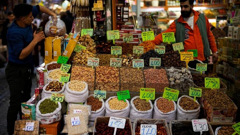 Sellers wait for customers in a food shop at Eminonu...