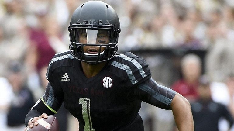 Kyler Murray of the Texas A&M Aggies scrambles upfield in...