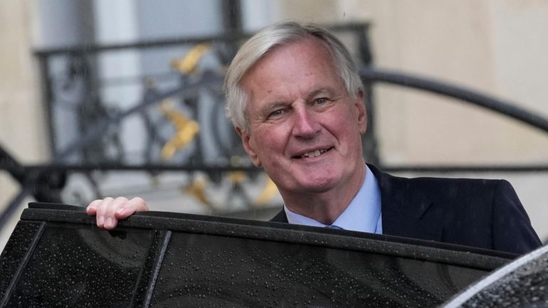 French Prime Minister Michel Barnier boards a car after the...