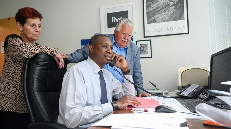 Darryl Johnson, admissions intake director, sitting, with JoAnn Vitale, director of day...