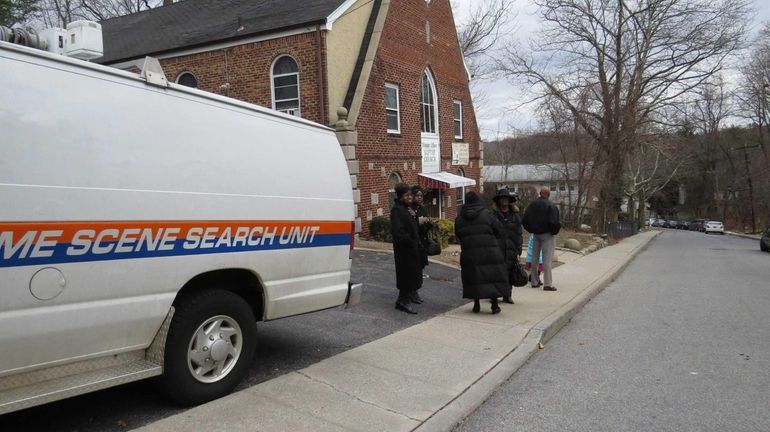 Nassau County Police investigate the scene of a robbery at...