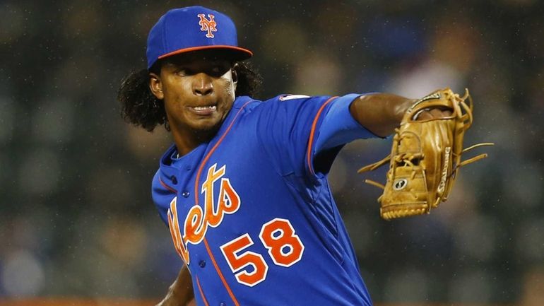 Jenrry Mejia of the Mets delivers a pitch in the...