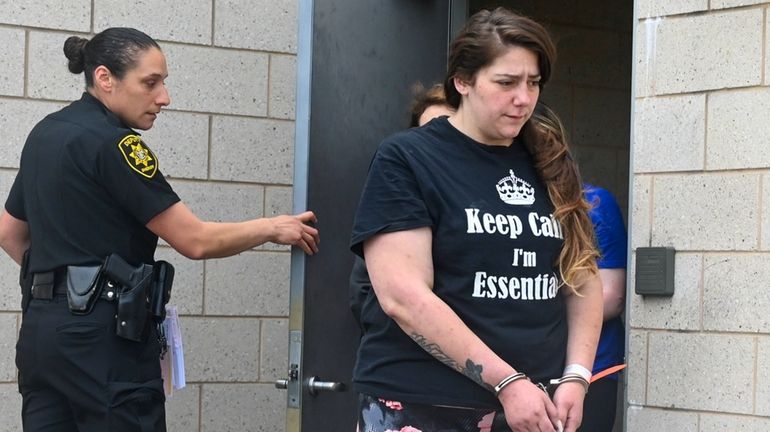 Johanna Iovino, 30, is led out of the Fourth Precinct...