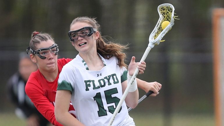 Floyd's Kayden Meyer (15) gets around Connetquot's Reagan Silhan (9)...