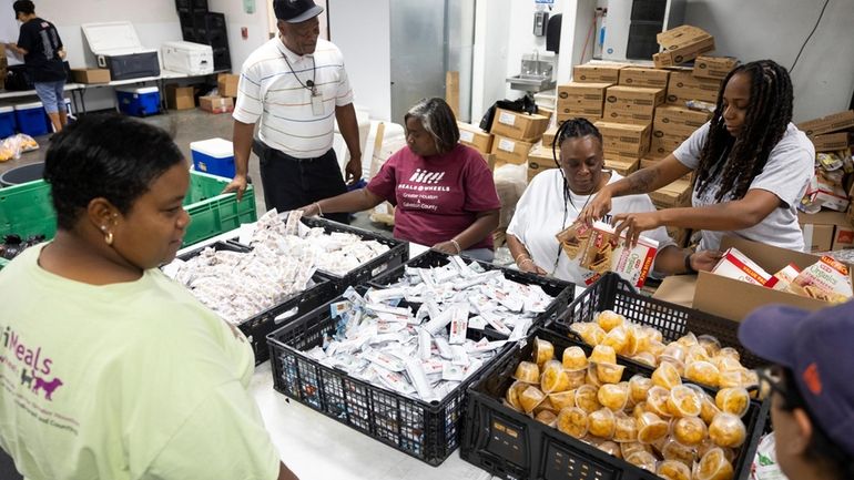 Meals on Wheels employees take advantage of an assembly line...