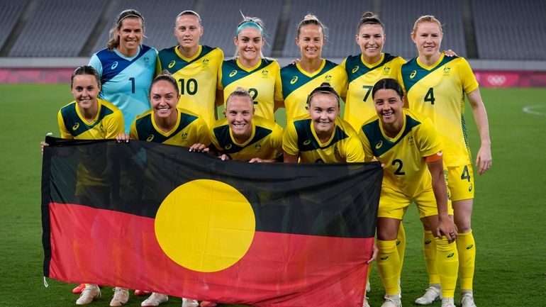 Australia players pose for a group photo with the Aboriginal...