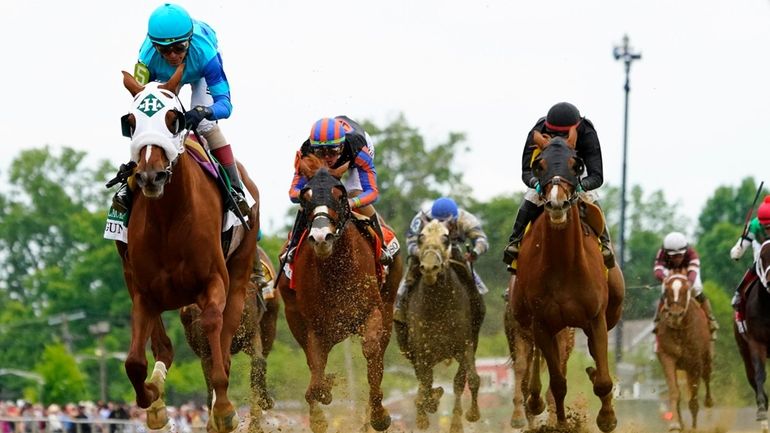 John Velazquez, left, atop Gun Song, wins the Black-Eyed Susan...