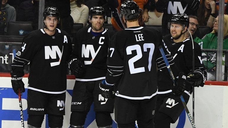 New York Islanders center John Tavares and teammates celebrate his...