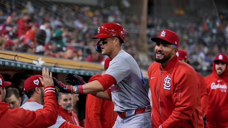 St. Louis Cardinals' Lars Nootbaar, center, celebrates with teammates in...