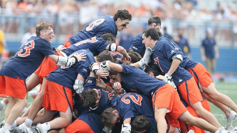 Manhasset celebrates their win during New York State High School...