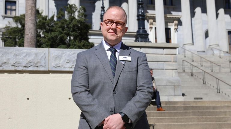 Chase Glenn, executive director of Alliance for Full Acceptance, stands...