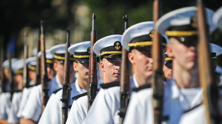 Midshipmen march down Brooks stadium during the viewing parade as...