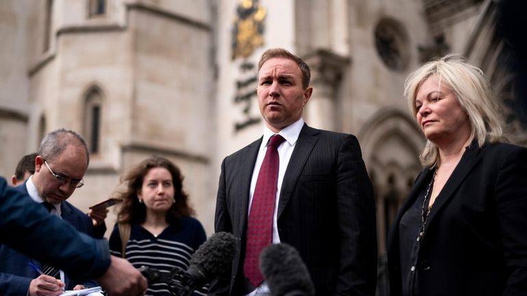 Financial market trader Tom Hayes speaks to the media, with...