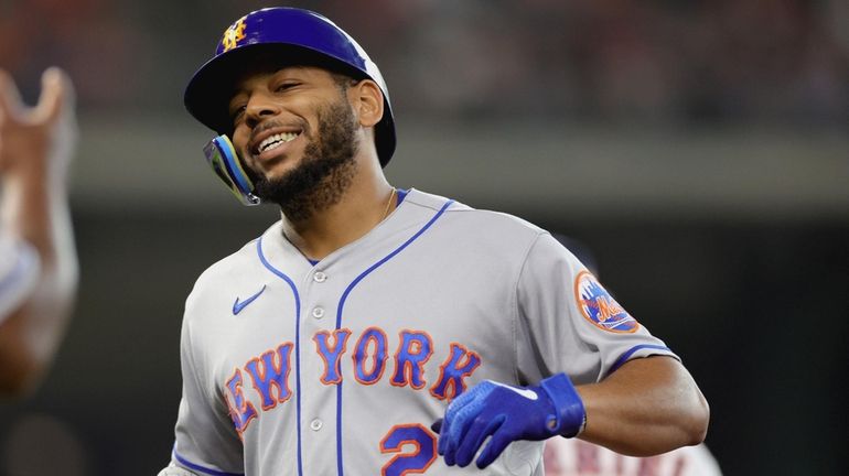 Dominic Smith of the Mets reacts after hitting a pop fly...