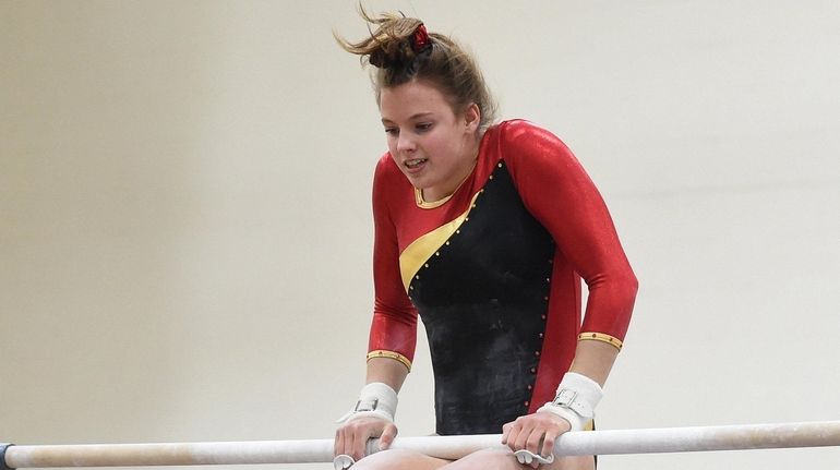 Riley McPartland of Sachem performs on the uneven bars during...