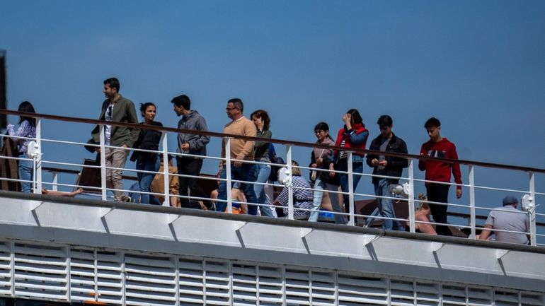 Passengers are photographed on the cruise ship MSC Armony, moored...