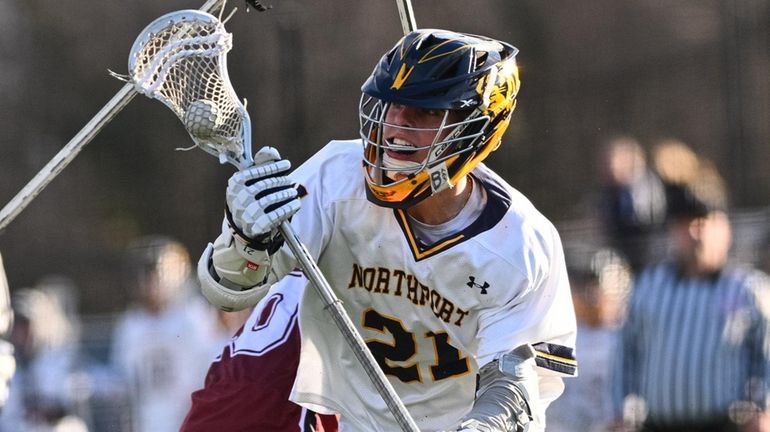 Timothy McLam of Northport rushes to the net past the...