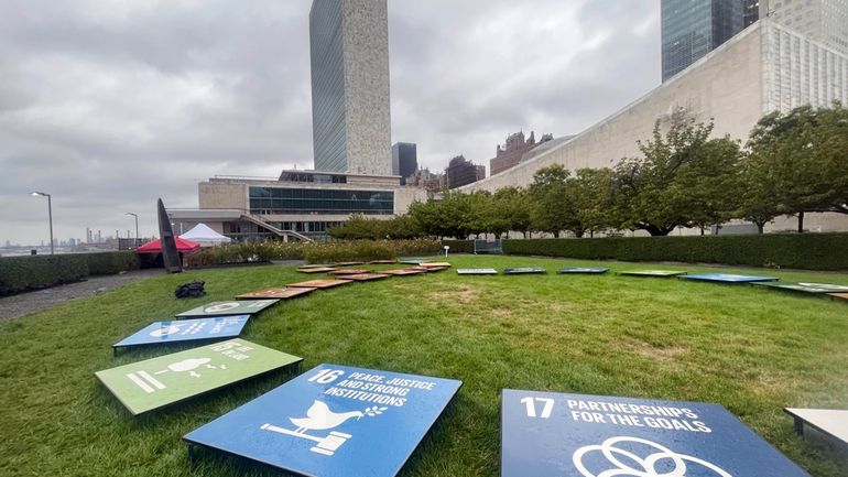 Tiles depicting the United Nations’ Sustainable Development Goals are displayed...