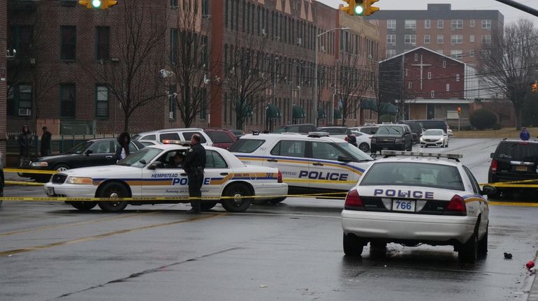 Police at the shooting scene in Hempstead on Monday.