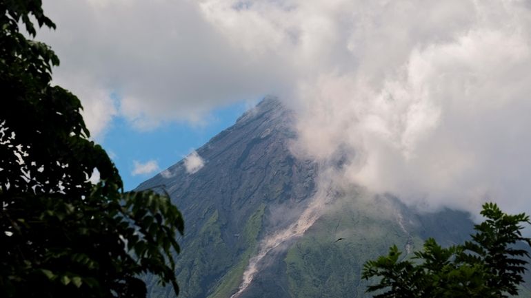 Mayon Volcano spews white smoke as seen from Daraga, Albay...