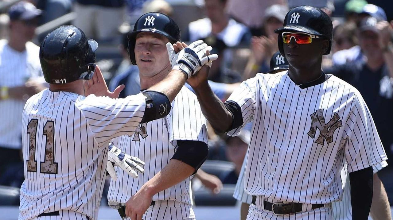 New York Yankees' Brett Gardner starts his head-first slide into third base  after hitting a triple in the first inning against the Kansas City Royals  on Sunday, August 17, 2008, at Yankee