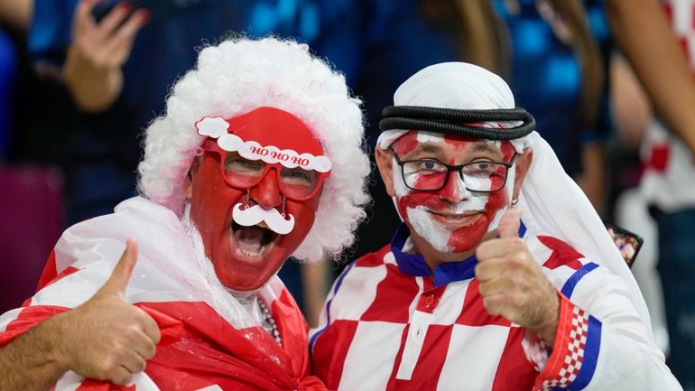 FILE - Croatia and Canada fans cheer ahead of the...