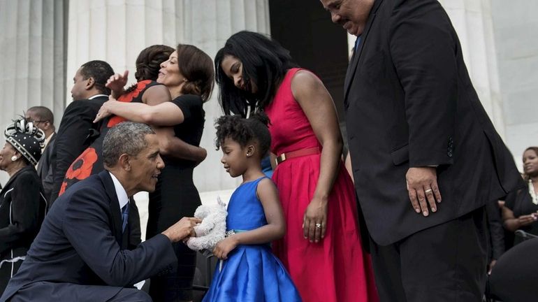 U.S. President Barack Obama talks with Yolanda Renee King while...