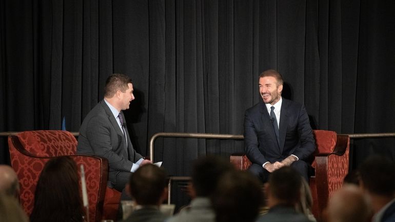 English soccer player David Beckham speaks at an event held...