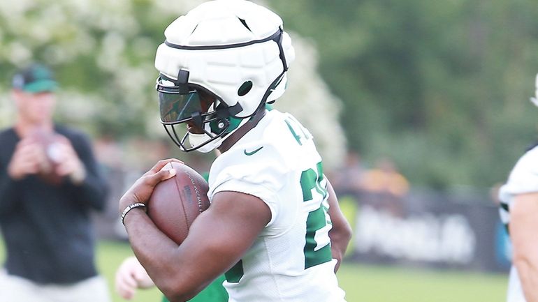 Jets running back Breece Hall does a drill during training camp...