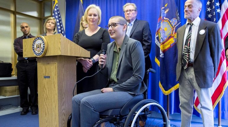 Sen. Kirsten Gillibrand listens as constituent Erin Schick speaks at...