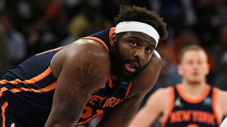 Knicks center Mitchell Robinson looks on against the Nets at...