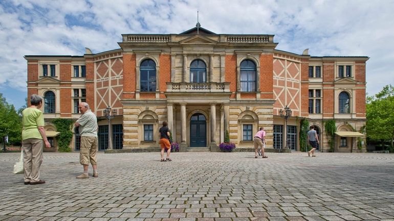 Visitors walk the grounds of the festival opera house "Festspielhaus"...