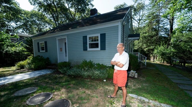 Donald Woods stands by the septic system in front of his...