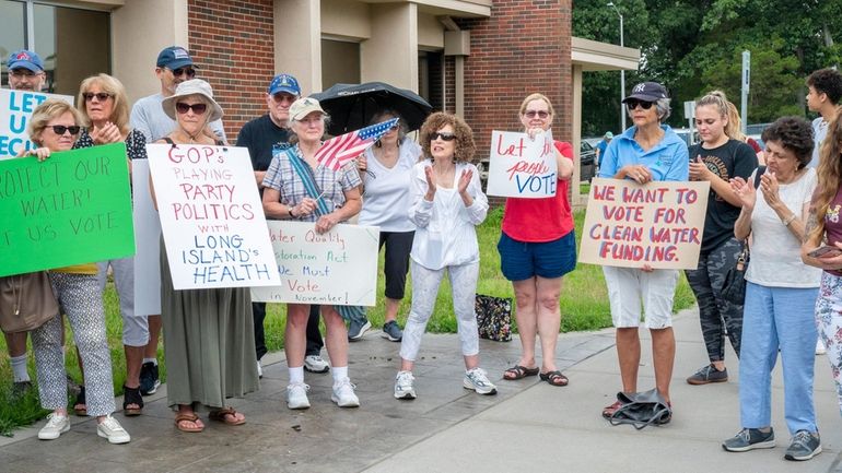 Democrats rally outside the Suffolk County Legislature building on Tuesday...