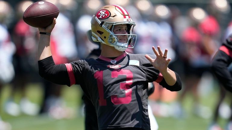 San Francisco 49ers quarterback Brock Purdy (13) throws a pass...