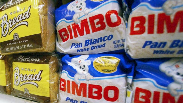 Bimbo bread is displayed on a shelf at a market...