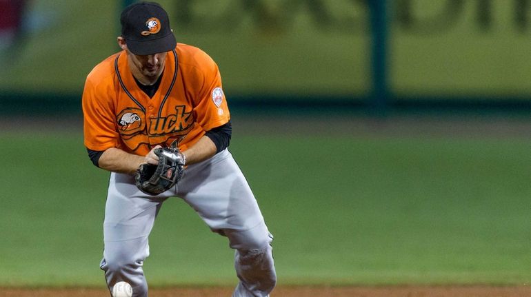 Long Island Ducks' Dan Lyons cannot handle the ball to...