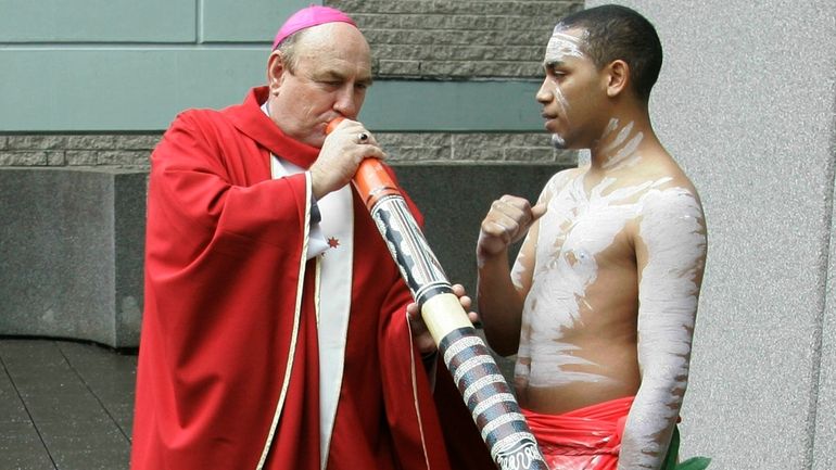 Bishop Christopher Saunders of Broome tries to play a digeridoo...