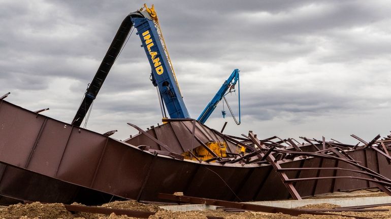 Twisted girders and debris cover the ground the day after...