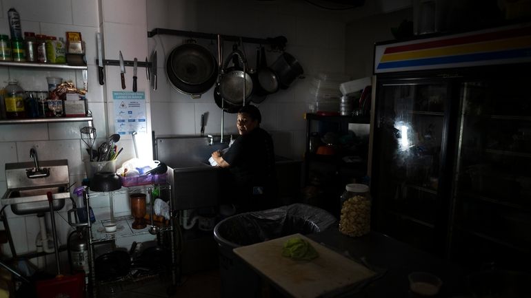 Las Palmas Cafe employees work with power from a generator...